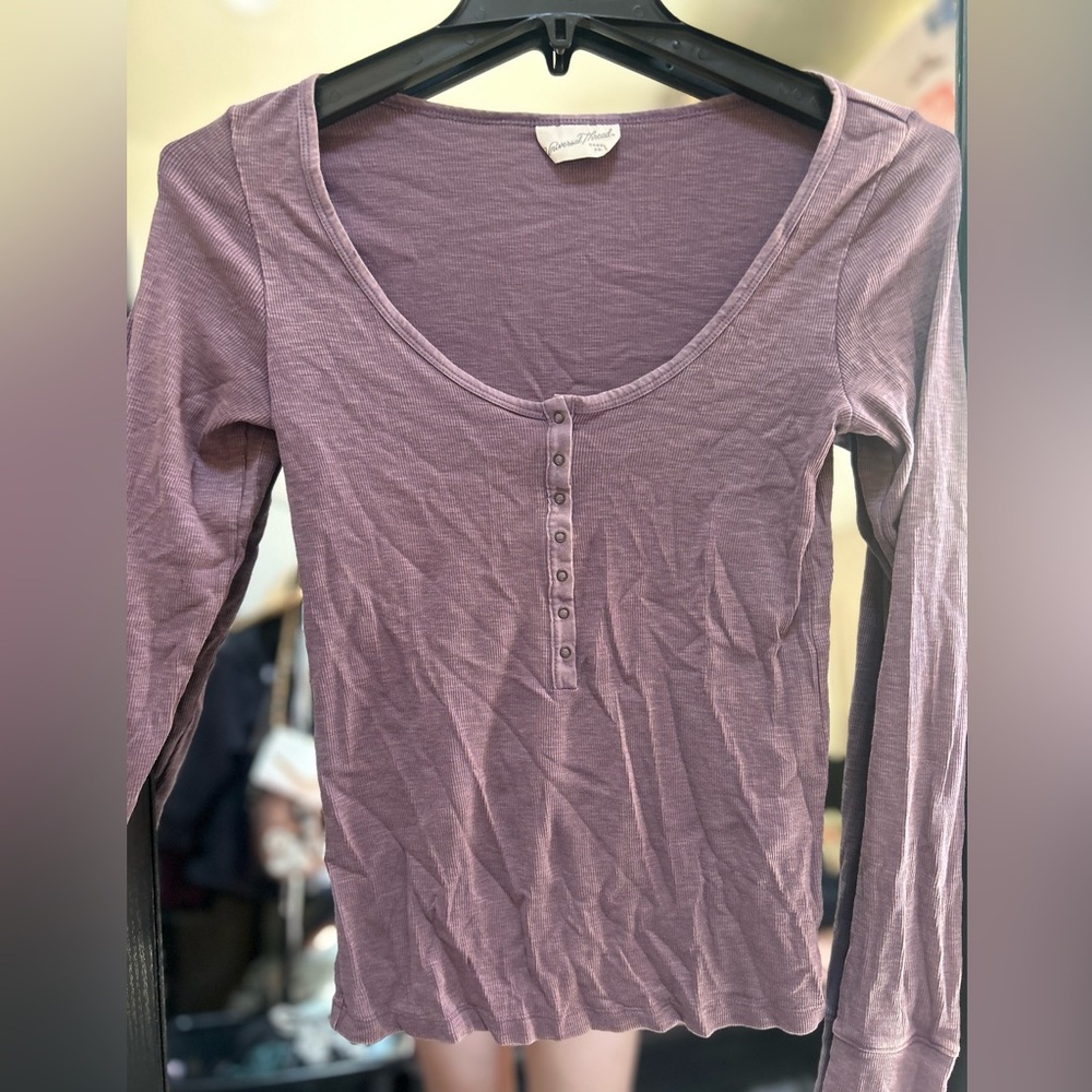 Purple long sleeve, with scoop neck line.
